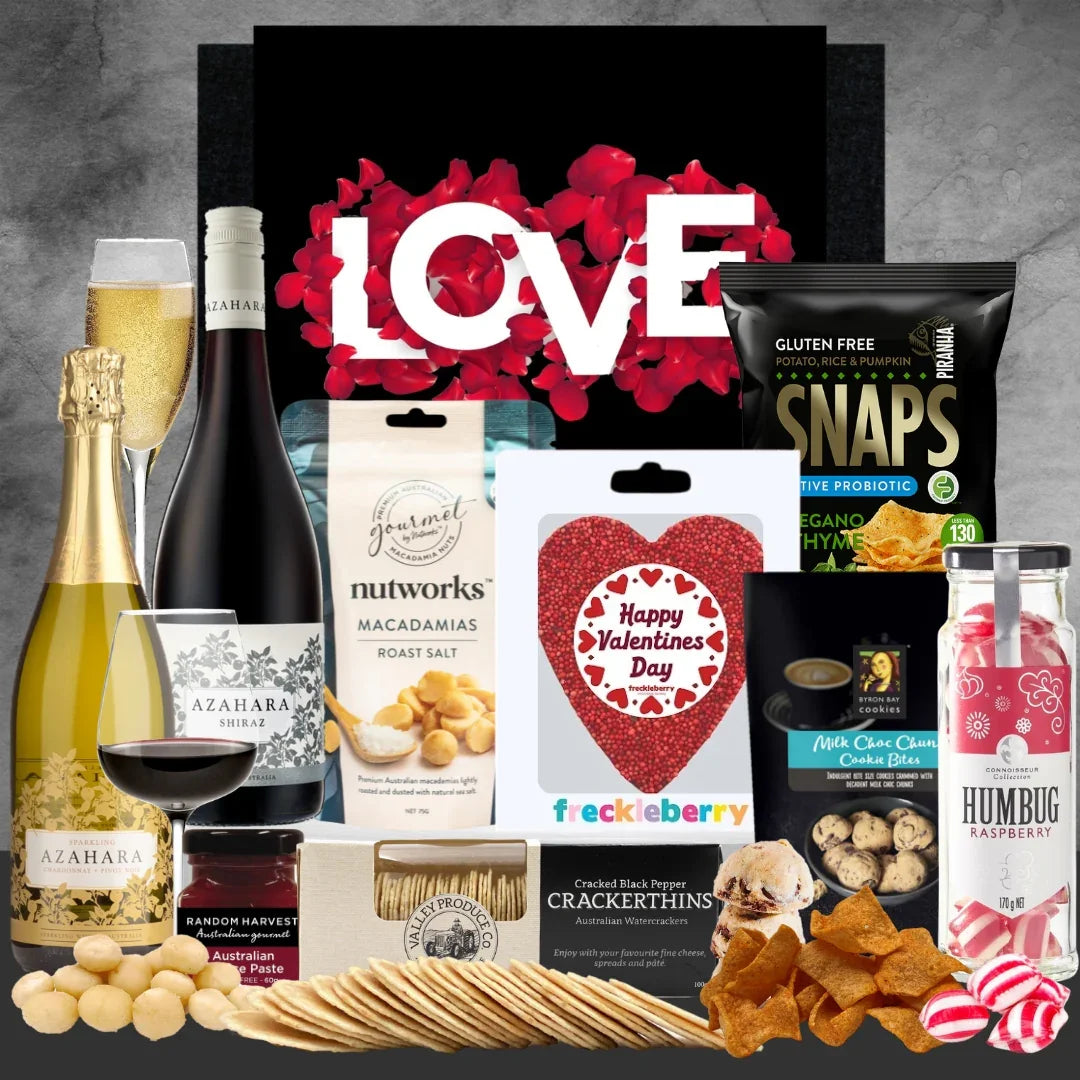 Gourmet gift basket with Valentine's Day-themed items on a gray background