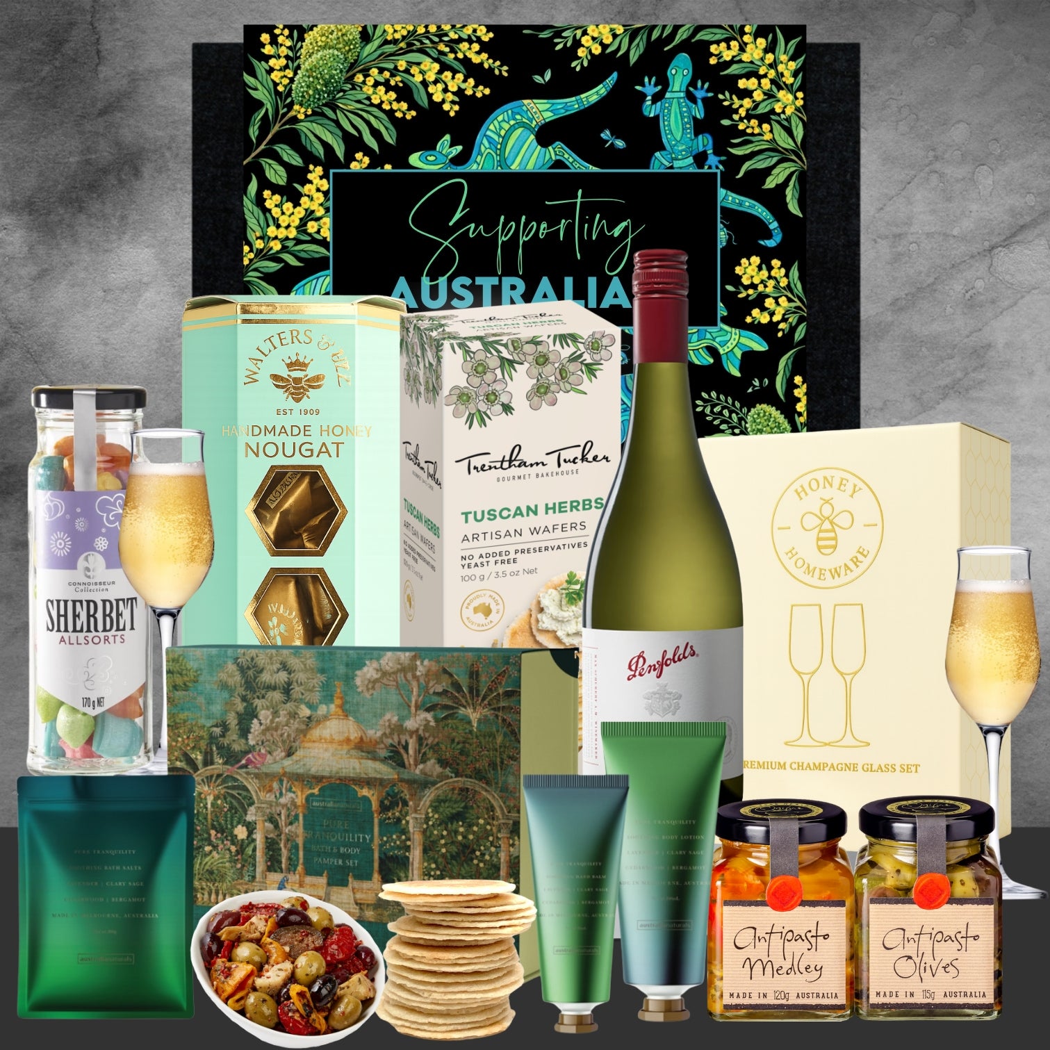 Gourmet gift basket with wine, snacks, and other items on a gray background