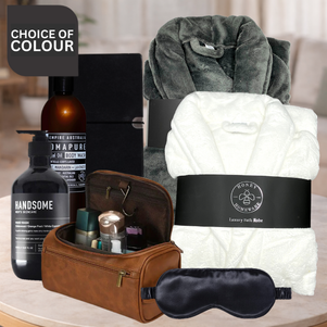 Grooming and relaxation products including a robe, sleep mask, and toiletries on a table.