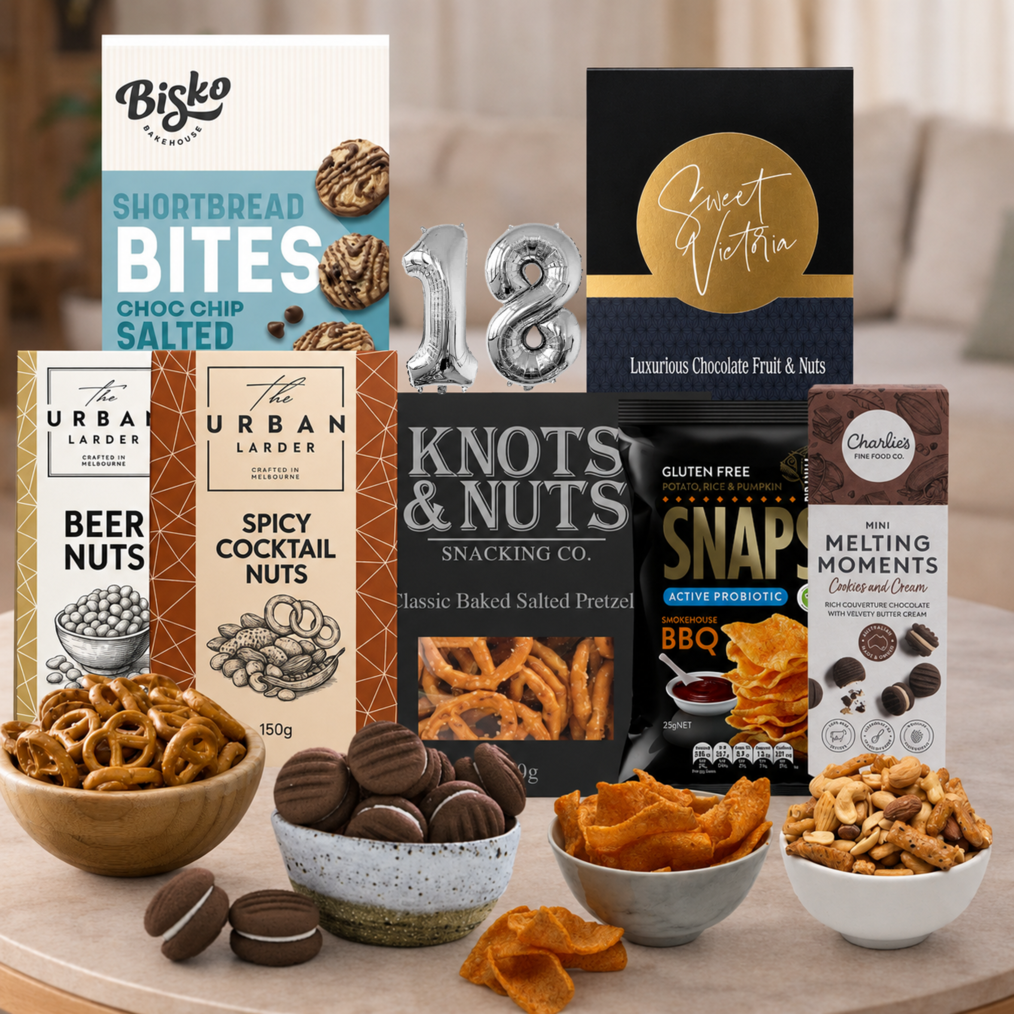 Celebrate an 18th birthday with the Snacking Combo Hamper from Tastebuds, featuring sweet and savoury treats, gourmet snacks and a free personalised card.