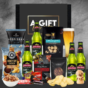 Gift set with beer, snacks, and candies on a gray background