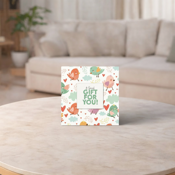 Greeting card with colorful design on a wooden table in a living room setting