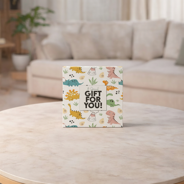Gift box with dinosaur design on a wooden table in a living room