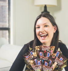 Person holding a bouquet of Nestle chocolate bars