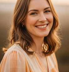 Woman with shoulder-length hair smiling outdoors