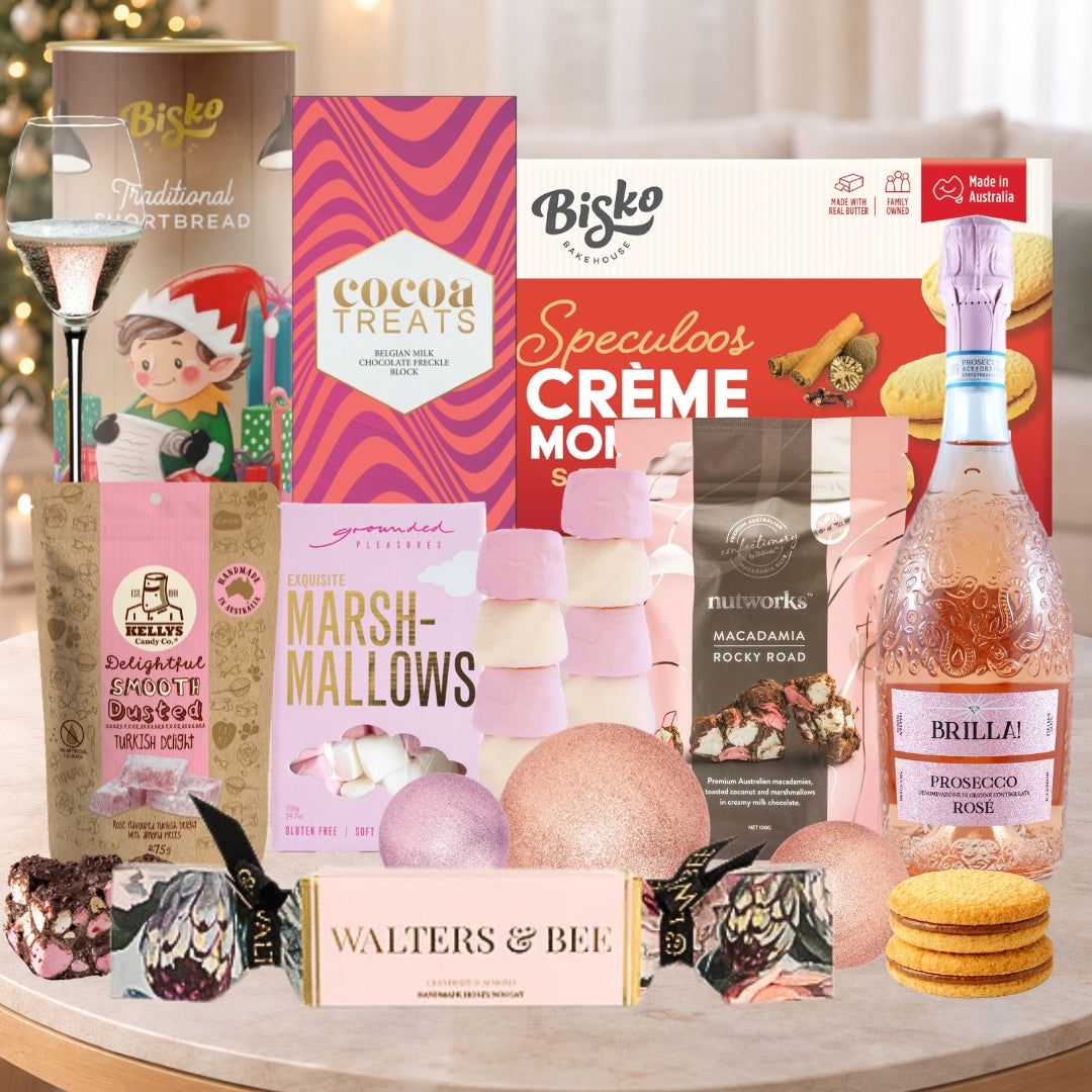 Assorted food items including Bisko bread, cocoa treats, marshmallows, and a bottle of Brilla Prosecco Rosé on a table.