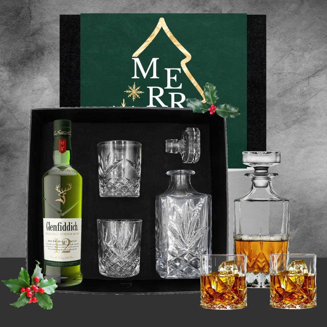 Glenfiddich whisky bottle with glasses and decanter set against a decorative backdrop with 'Christmas Gift' text.