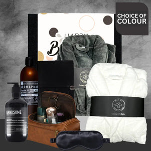 Grooming and relaxation products including a robe, sleep mask, and toiletries on a gray background.