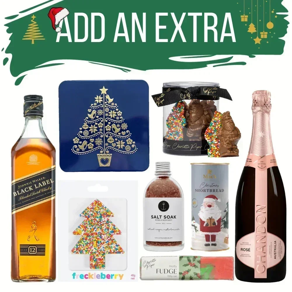 Collection of Christmas-themed products including a bottle of Johnnie Walker Black Label whisky, a bottle of Perrier-Jouét champagne, and various gift items on a white background.