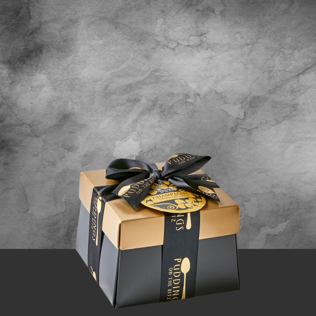 Premium black and gold Christmas pudding gift box with black ribbon and festive label