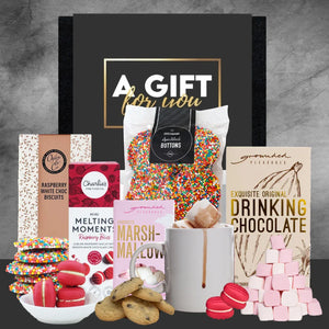 Assorted gift items including a mug, cookies, and chocolate bars on a gray background with 'A Gift for You' text.