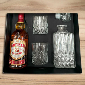 Chivas Regal bottle with two glasses and a decanter on a black tray