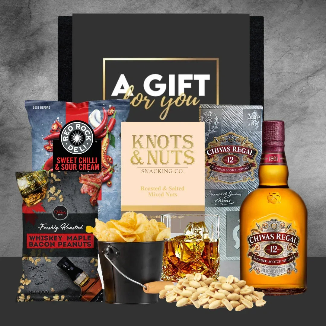 Gift set with Chivas Regal whiskey, snacks, and a 'Gift for You' card on a gray background.