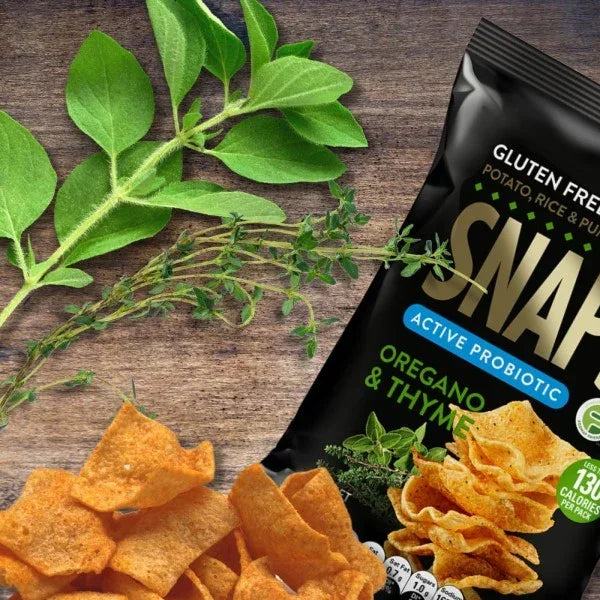 Packaged gluten-free chips with herbs on a wooden surface