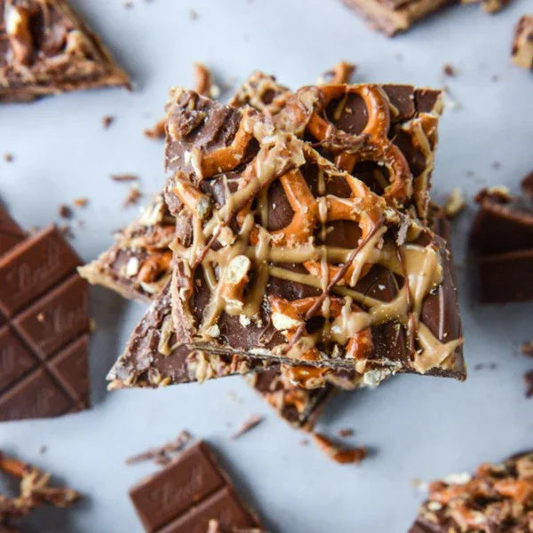 Chocolate bar with pretzel pieces on a marble surface