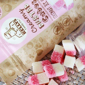 Kelita's Gummy Bear Candy with pink and white gummies on a woven surface