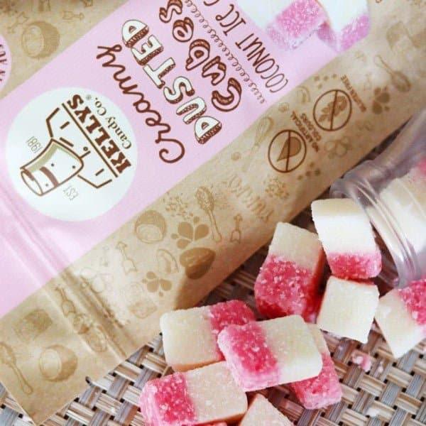 Kelita's Gummy Bear Candy with pink and white gummies on a woven surface